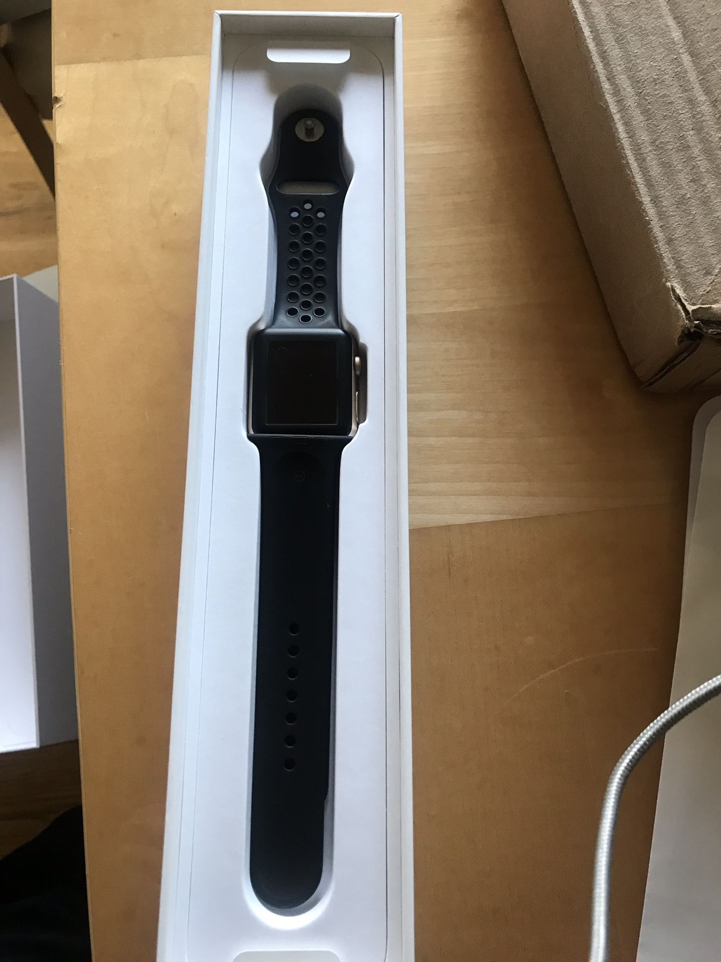 Gold aluminum Apple Watch series 1 with extras