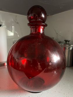 Red glass bottle with lid