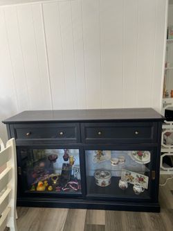 Black buffet with silverware tray in the drawer.