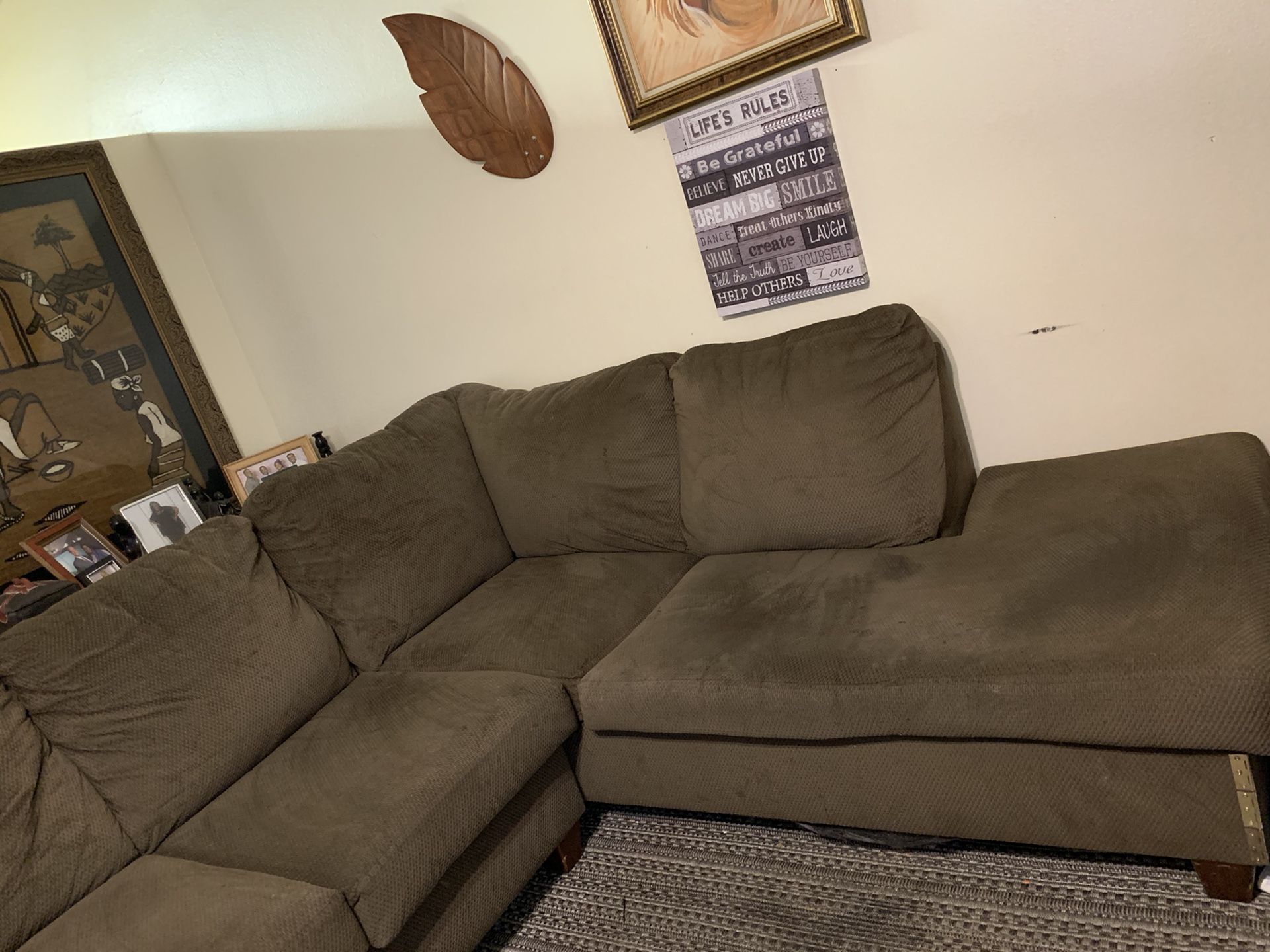 Beige 2piece sectional with an oversized chair w/storage ottoman. It is good condition with a few spots from wear & tear!