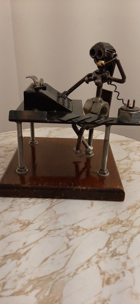 Handmade from metal nuts, bolts, washers, and wire.