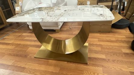 Beautiful dining table on metal golden base with marble top