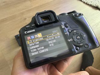 Canon EOS Rebel DSLR with a Sigma zoom lens attached