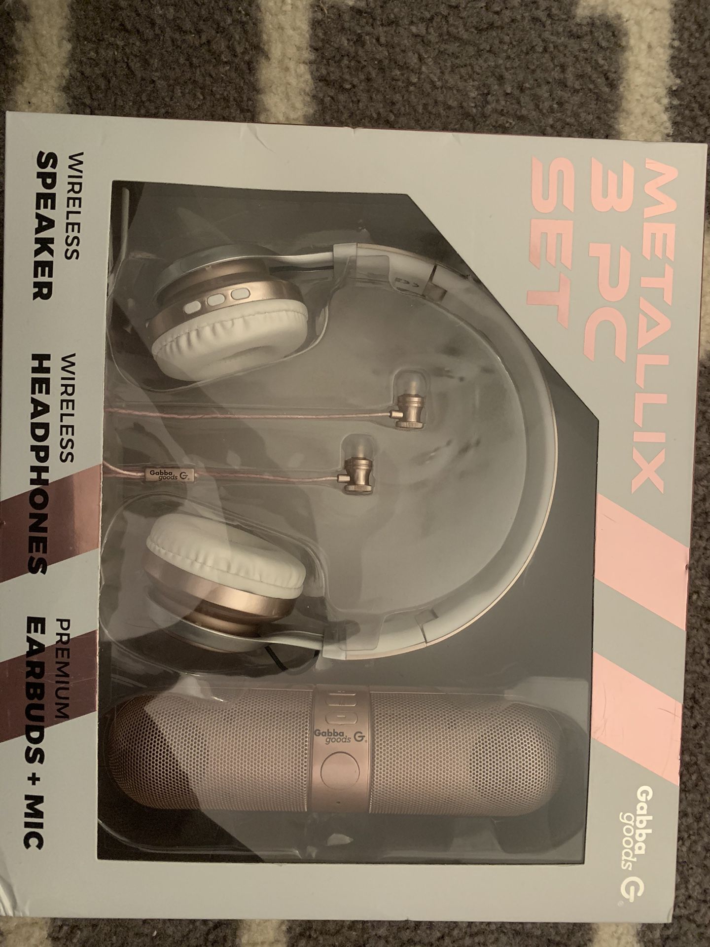 Brand new 3 piece head phone and portable speaker set. New in the box. Rose gold.