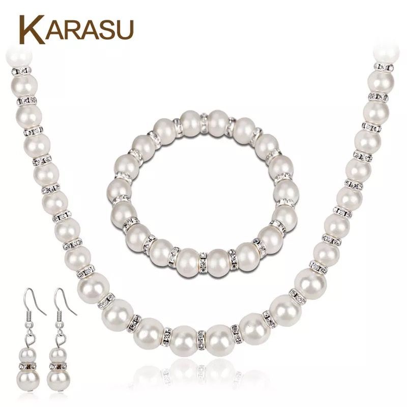 Set of imitation pearls contains (earrings, necklace and bracelet)