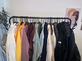 Clothing rack with two cloth shelves and hanging hooks on both sides