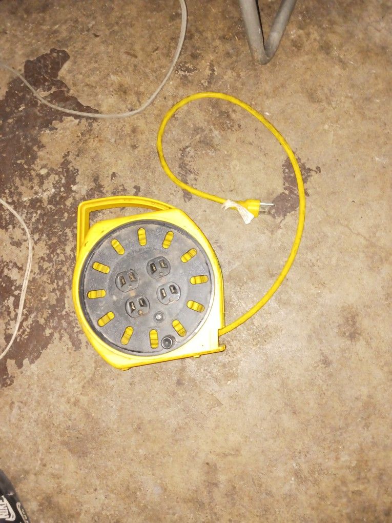  Alert Stamping Multi-Outlet Manual Wind-Up Cord Reel. It is a cord reel with multiple outlets and a built-in circuit breaker.  $25