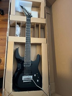Guitar is New old stock Jackson Pro SL7, Gloss Black