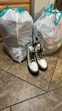 White Doc Martins and two bags of teen clothes