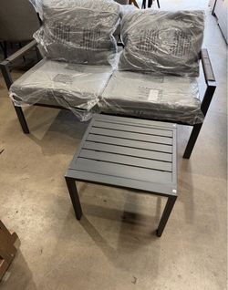 Gray bench with coffee table and cushions
