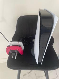 PS5 with controllers  and chair