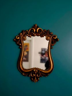 French Baroque style mirror features a highly ornate gold frame. 10"×20"