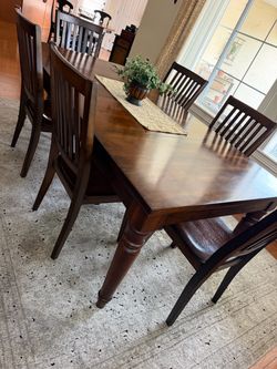 Wooden dining room table with six chairs