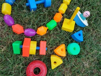 Children's plastic shapes, beads, boat and figure