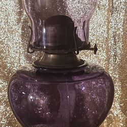 vintage purple glass oil lamp, likely a pressed glass or amethyst glass collectible from the early 20th century. 