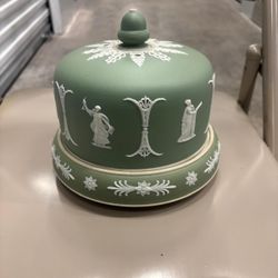 This is a Wedgwood Jasperware cheese dish, likely dating from the Victorian era around the 1870s, known for its iconic sage green ground 