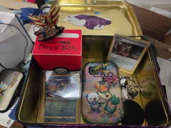 Tin of random Pokémon stuff cards figures pins toploaders sleeves