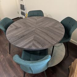 47” Gray Round Wood Grain Dining Table With 4 Teal Upholstered Chairs