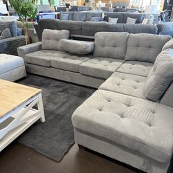 Sectional with drop down cupholder