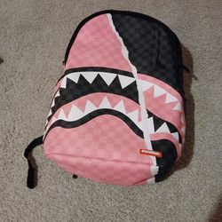 A Pink And Black Sprayground Backpack 