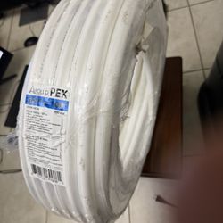 tubería PEX blanca Apollo de 3/4 pulgadas por 100 pies (modelo PW10034) diseñada para sistemas de tuberías de agua potable. 