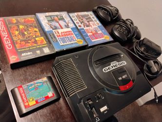 Sega Genesis console with 2 controllers and 4 games