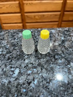 Vintage Small Clear Glass Pair of Salt and Pepper Shakers.  Size approximately shakers 2 1/4 inches tall.  Preowned never used.