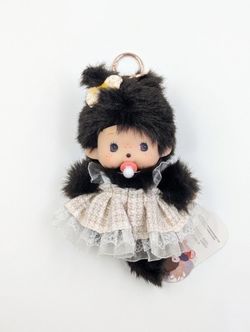 Monchhichi doll with a dress outfit. Looks like “Punch” the monkey