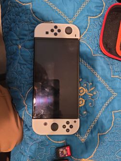 Nintendo switch oled with 4 games and a case