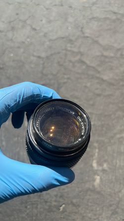 Olympus OM-system Zuiko manual focus lens with an attached 49mm HOYA UV filter.