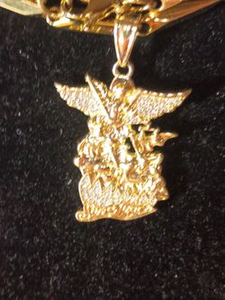 18 karat gold plated Michael the archangel with cubic zirconium on a gold beaded necklace that stainless steel underneath with lobster clamps 25 in Lo