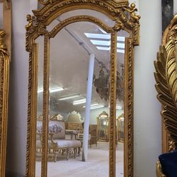 Baroque Gilded Mirror LOOK UP Ornate Baroque-style full-length gilded mirror with cherub figures. TIME PERIOD 18th Century Style ORIGIN Italy ESTIMATE