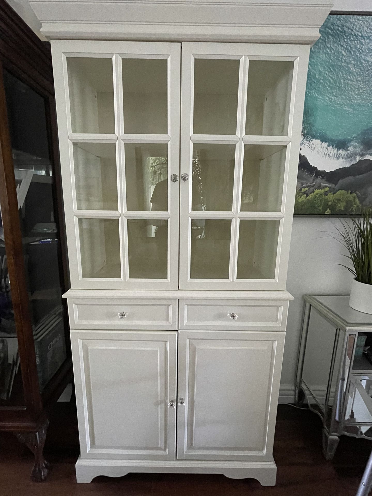 Tall White Curio Cabinets With Glass Fronts, Shelves And Drawers