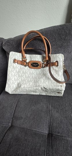Stylish Michael Kors satchel has signature MK monogram canvas with tan leather