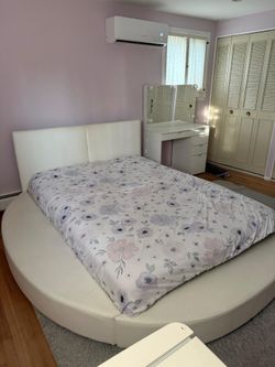 Round queen sized bed with night stand