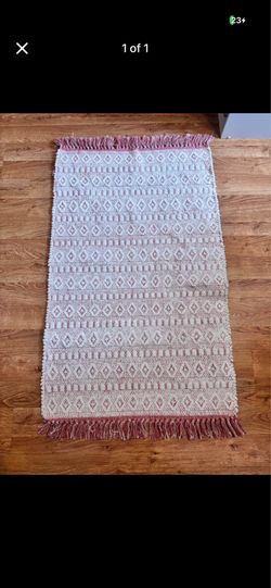 Pink and white woven carpet