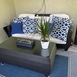 Dark Rattan Loveseat, 2 Chairs, 2 Ottomans, & Glass Table. Cushions Included.