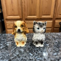 Vintage Ceramic Cat & Dog Pair of Salt and Pepper Shakers.  Preowned never used.  Has been on display in a cabinet with a very large salt and pepper s