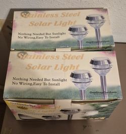NEW IN ORIG BOXES-Stainless and Glass- Four solar lights. $25.  Foothills/Fortuna road