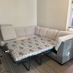 Two Piece Grey Couch Set With Foldable Bed And Covers Plus Free Coffee Table