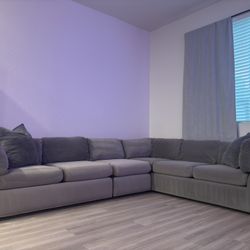grey L - shaped modular couch 