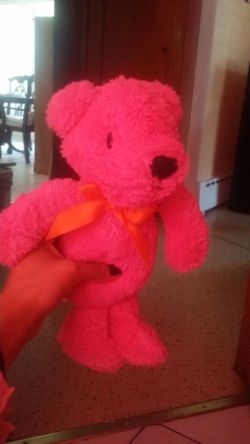 Hot pink teddy bear with orange ribbon