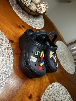 Stylish black platform clogs featuring colorful charms.NewSize 39