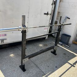 barbell, and a squat rack  and Olympic dumbbell handles.