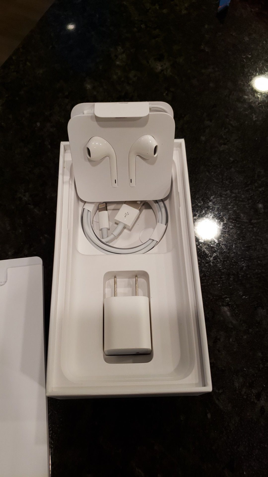 Silver or black iPhone 7 box with charger, cord and original earbuds