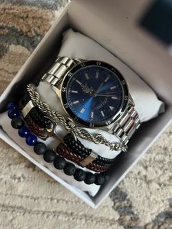 This is a U.S. Polo Assn. men's 4-piece watch boxed set, featuring a silver-tone bracelet watch with a navy blue dial.