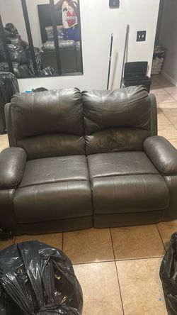 A 3 seat and 2 seat black couch