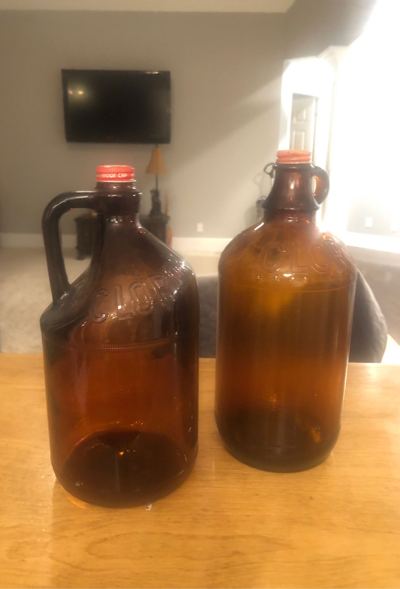 2 antuque 1/2 gallon amber glass Clorox bottles.