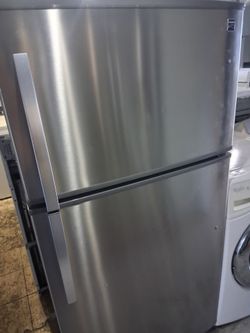 Newer model of Kenmore stainless steel top and bottom apparment zide fridge fully functional