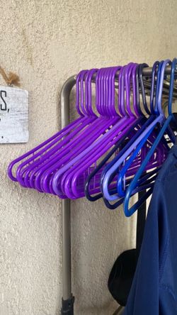 About 16 Purple plastic hangers $5.00